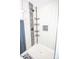 An updated shower featuring decorative tile accents, a rainfall shower head, and built-in shelving at 5020 Foster Rd, Cleveland, NC 27013