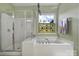 Relax in this bathroom with soaking tub, shower and stained glass window at 55327 Derringer Ave, Fort Mill, SC 29707
