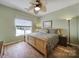 Bedroom with hardwood floors, large bed and ceiling fan at 55327 Derringer Ave, Fort Mill, SC 29707