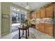 Eat-in kitchen with wood cabinets, access to backyard, and a breakfast bar at 55327 Derringer Ave, Fort Mill, SC 29707
