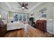 Main bedroom with hardwood floors, large windows, and TV at 55327 Derringer Ave, Fort Mill, SC 29707