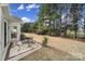 Relaxing backyard patio with seating area and view of the wooded backyard at 55327 Derringer Ave, Fort Mill, SC 29707