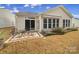 Private backyard patio adjacent to sunroom and surrounded by trees at 55327 Derringer Ave, Fort Mill, SC 29707