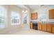 Kitchen with wooden cabinets, and corner window at 5619 Glen Cove Dr, Charlotte, NC 28269