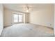 Spacious bedroom with ceiling fan and neutral carpeting at 5843 Harris Grove Ln, Charlotte, NC 28212