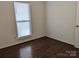 Simple bedroom with dark hardwood floors and window blinds at 5938 Trysting Rd, Charlotte, NC 28227