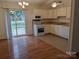 Kitchen with white cabinets, appliances, and wood floors at 5938 Trysting Rd, Charlotte, NC 28227