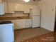 Galley kitchen with white cabinets and appliances at 5938 Trysting Rd, Charlotte, NC 28227