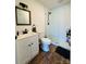 Modern bathroom with white vanity, shower, and wood-look floors at 813 S Zion St, Landis, NC 28088