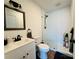 Modern bathroom with white vanity, shower, and wood-look floors at 813 S Zion St, Landis, NC 28088
