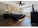 Bright bedroom with a king-size bed and hardwood floors at 813 S Zion St, Landis, NC 28088