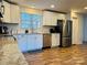 Modern kitchen with white cabinets and wood floors at 813 S Zion St, Landis, NC 28088