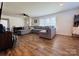 Spacious living room featuring a large sectional sofa and wood-look floors at 813 S Zion St, Landis, NC 28088