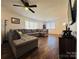 Living room with sectional sofa, wood floors, and ceiling fan at 813 S Zion St, Landis, NC 28088
