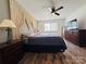 Main bedroom with king-size bed, wood floors, and ceiling fan at 813 S Zion St, Landis, NC 28088