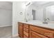 Double vanity bathroom with wood cabinets and a large mirror at 8436 Dawson Ln, Locust, NC 28097