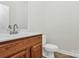 Simple bathroom with a vanity, toilet and mirror at 8436 Dawson Ln, Locust, NC 28097