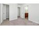 Well-lit bedroom with carpet flooring and access to a bathroom and closet at 8436 Dawson Ln, Locust, NC 28097