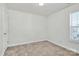 Simple bedroom with neutral walls, carpet flooring, and large window at 8436 Dawson Ln, Locust, NC 28097