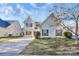 Two-story house with a beige exterior, attached garage, and landscaping at 8436 Dawson Ln, Locust, NC 28097