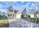 Two-story house with a gray roof, attached garage, and driveway at 8436 Dawson Ln, Locust, NC 28097