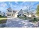 Two-story house with a beige exterior, attached garage, and driveway at 8436 Dawson Ln, Locust, NC 28097