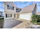 Two-story house with a beige exterior, attached garage, and landscaping at 8436 Dawson Ln, Locust, NC 28097