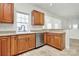 Kitchen with wood cabinets, stainless steel dishwasher, and tile floor at 8436 Dawson Ln, Locust, NC 28097