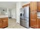 Stainless steel refrigerator in kitchen with wood cabinets at 8436 Dawson Ln, Locust, NC 28097