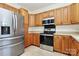 Modern kitchen with stainless steel appliances and wood cabinets at 8436 Dawson Ln, Locust, NC 28097