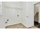 Laundry room with shelving and access to stairs at 8436 Dawson Ln, Locust, NC 28097