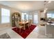 Dining area with red rug, and wooden table, near kitchen at 9027 Daring Ct, Charlotte, NC 28215