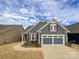Gray two-story house with a two-car garage and landscaping at 9027 Daring Ct, Charlotte, NC 28215