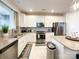 Modern kitchen with stainless steel appliances and an island at 9027 Daring Ct, Charlotte, NC 28215