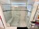 Large walk-in shower with marble tile and a built-in seat at 9027 Daring Ct, Charlotte, NC 28215