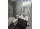 Updated bathroom with a stylish vanity and gray tile at 104 Rice St, Kannapolis, NC 28081