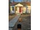 Charming white cottage with red door, walkway, and mailbox at 104 Rice St, Kannapolis, NC 28081