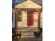 Renovated front entry with red door and wooden posts at 104 Rice St, Kannapolis, NC 28081