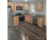 Updated kitchen with wood cabinets and stainless steel appliances at 104 Rice St, Kannapolis, NC 28081