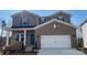 New construction two story brick home features a two car garage and a covered porch at 116 Sentinel Ct, Mooresville, NC 28115