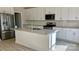 Bright kitchen features a large island, stainless steel appliances, granite countertops and white cabinets at 116 Sentinel Ct, Mooresville, NC 28115