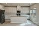 This kitchen features a large island, stainless steel appliances, granite countertops and white cabinets at 116 Sentinel Ct, Mooresville, NC 28115