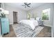 A bright bedroom features wood-look floors, a ceiling fan, an area rug, and natural light from dual windows at 117 Chavis Ln, Lincolnton, NC 28092