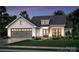 Two-story craftsman style home with gray and white exterior, attached garage, and landscaped lawn at 117 Chavis Ln, Lincolnton, NC 28092
