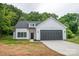 New construction featuring white siding, gray garage door, black trim, and professionally landscaped front yard at 117 Chavis Ln, Lincolnton, NC 28092