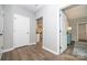 Hallway with neutral walls and hardwood floors leading to the living room and bedroom at 117 Chavis Ln, Lincolnton, NC 28092
