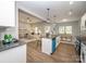 Bright, open kitchen with stainless steel appliances and island seating overlooking the living room at 117 Chavis Ln, Lincolnton, NC 28092