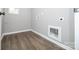 A simple laundry room with grey walls, wood-look floors, and washer/dryer hookups offers functionality at 117 Chavis Ln, Lincolnton, NC 28092