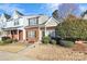 Two-story brick townhome with a charming front porch and landscaping at 15117 Deshler Ct, Charlotte, NC 28273