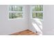 Bright bedroom with wood floors, white walls and two large windows at 2504 S Cannon Blvd, Kannapolis, NC 28083
